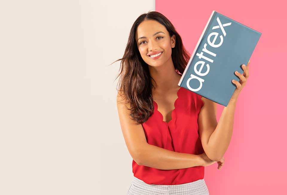 Woman holding Aetrex Box