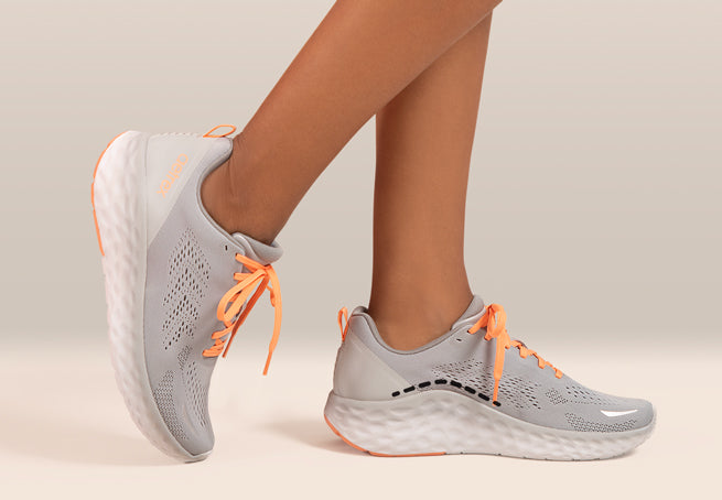 grey sneaker with orange laces