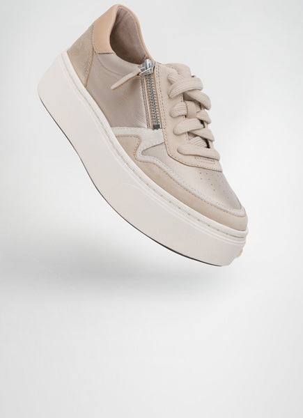 Beige sneaker with a platform sole on a light gray background