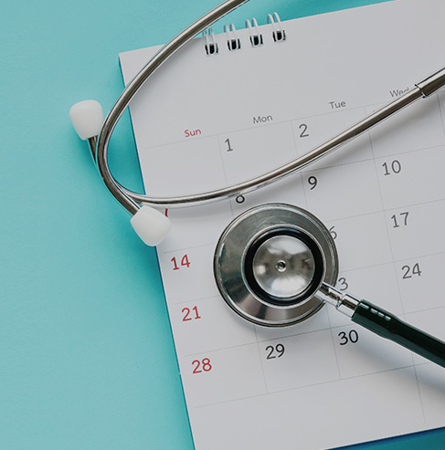 stethoscope on top of calendar