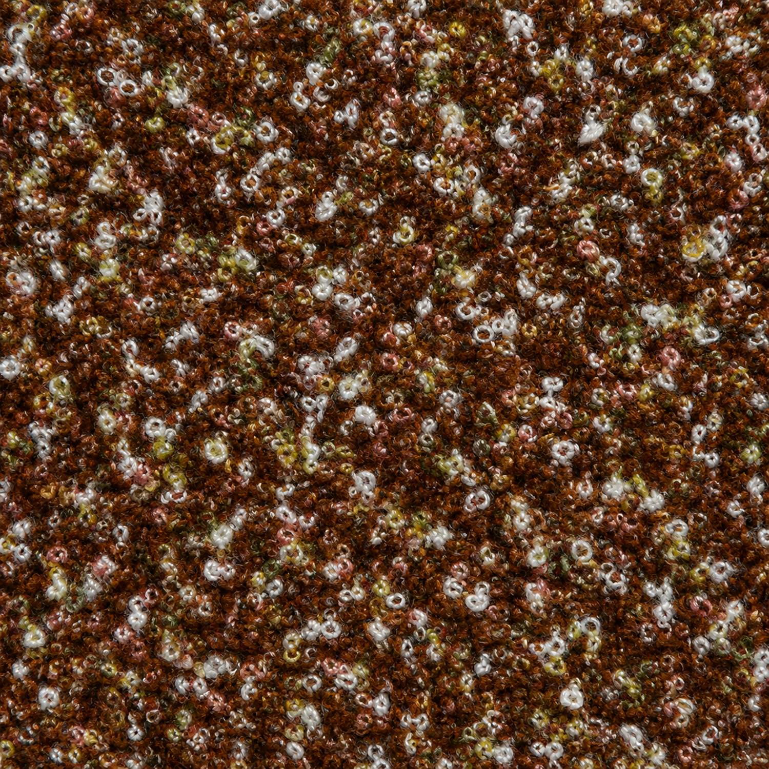 Close-up of a textured brown fabric with small white and pink flowers.