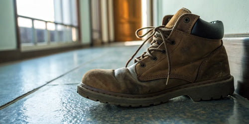 A woman's work boot ready for the best insoles for standing all day.