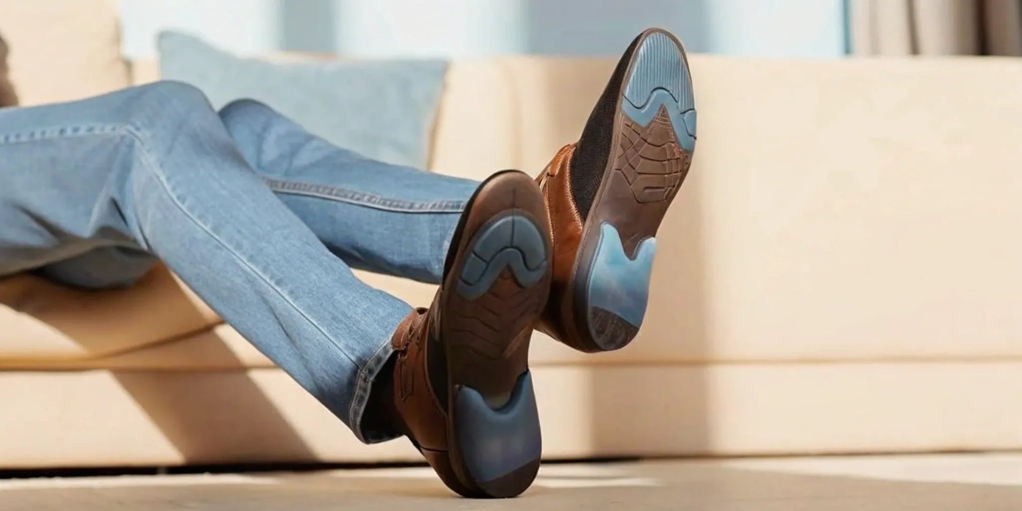 A person's feet in brown shoes with the best insoles for Morton's neuroma pain.