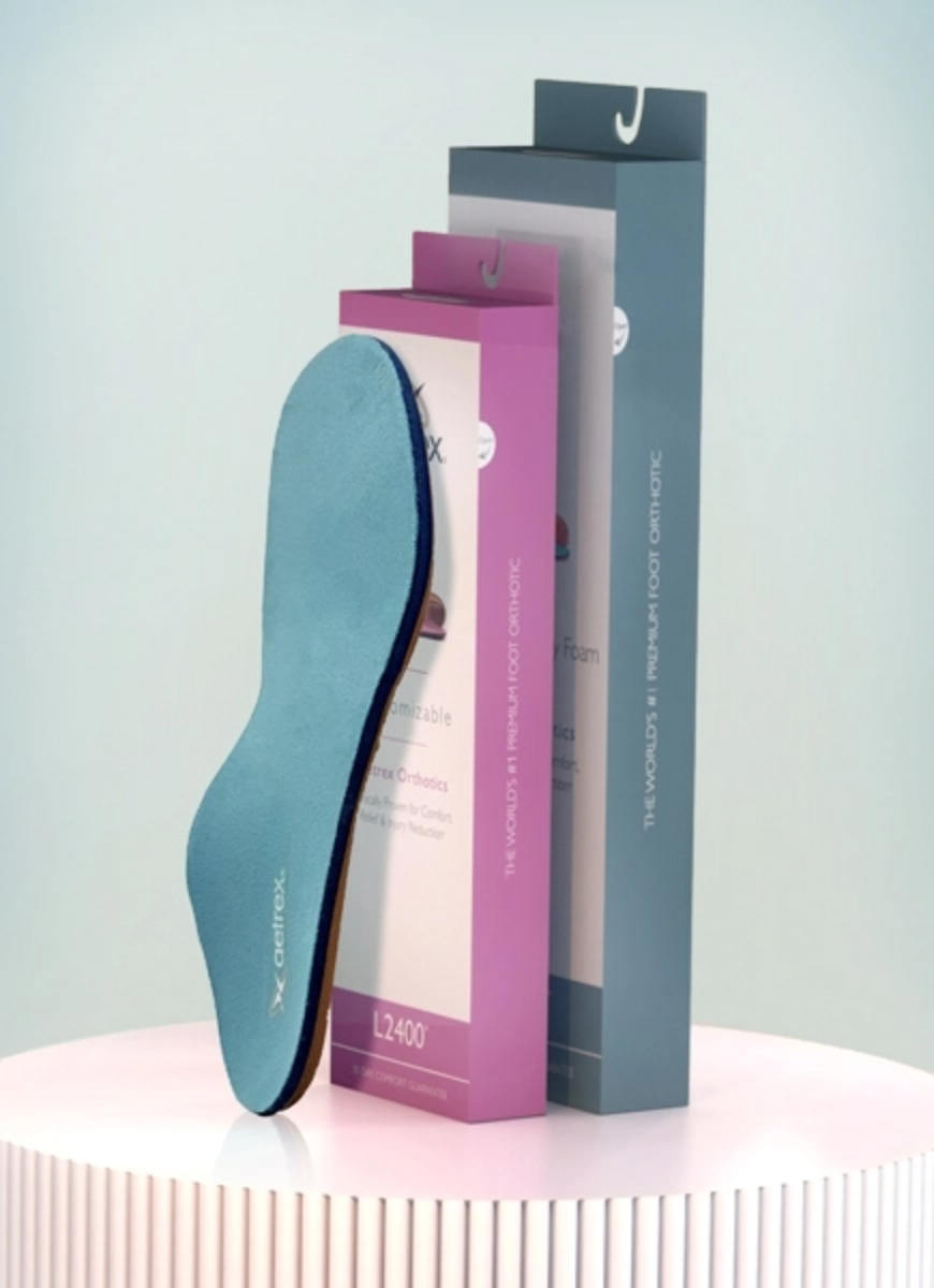 blue orthotic leaning against 2 orthotic boxes 