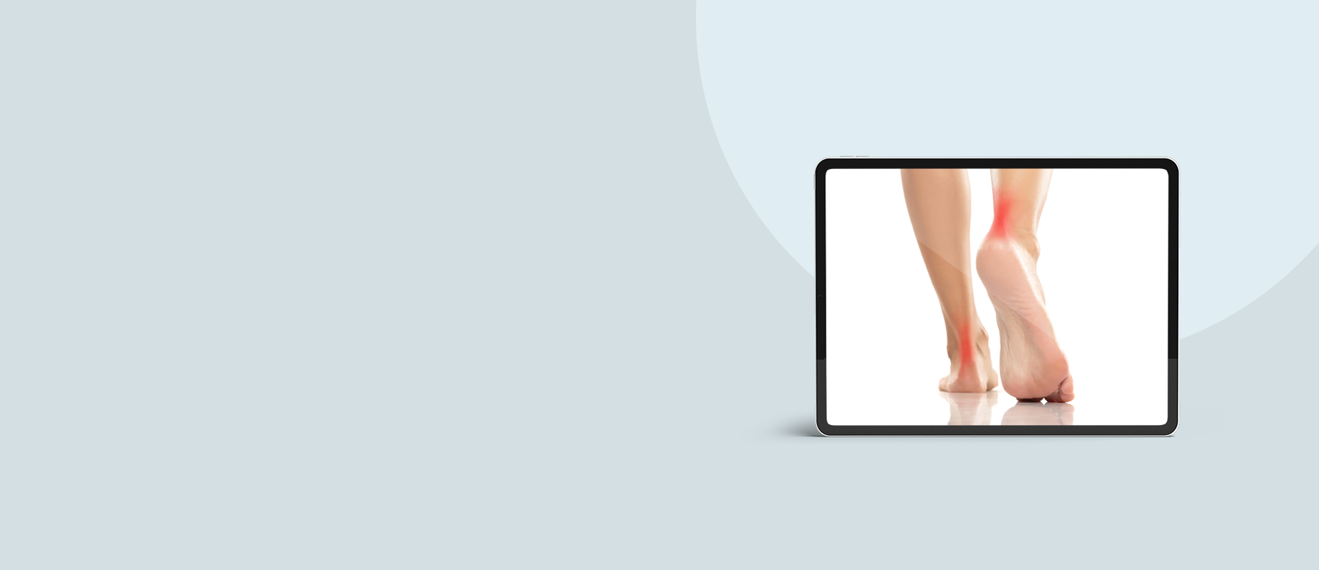 Tablet displaying a close-up of feet on a light blue background