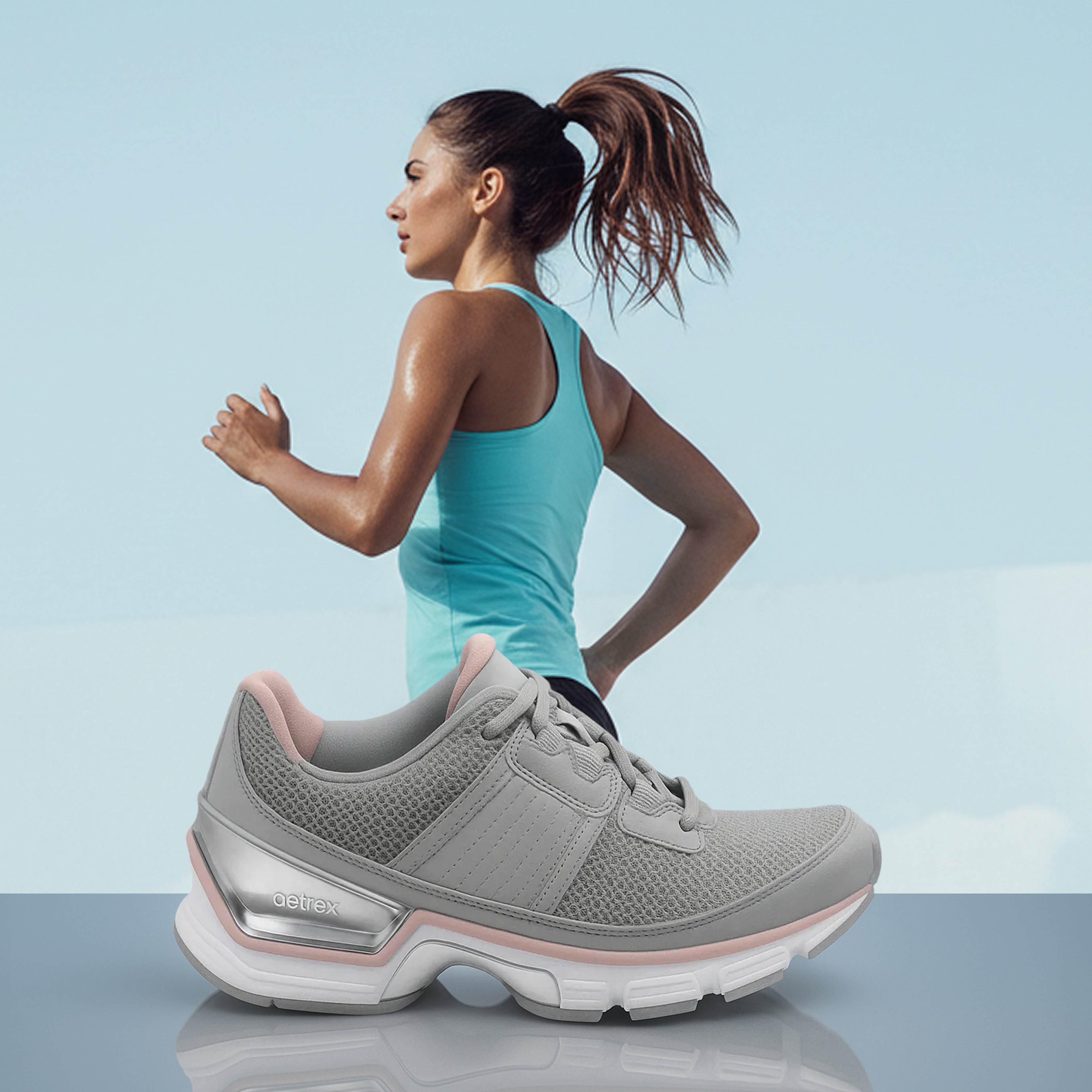 Woman in athletic wear with a gray running shoe in the foreground on a light blue background