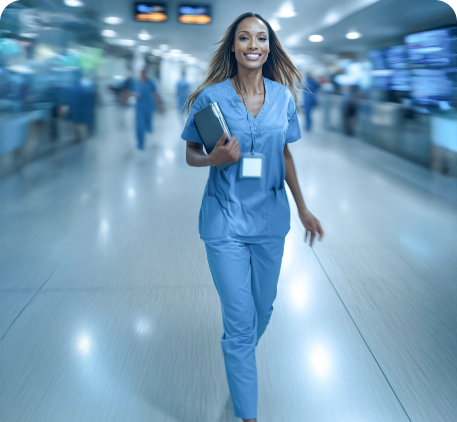 Nurse in blue scrubs walking in a hospital corridor