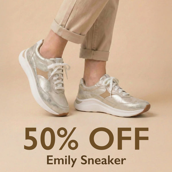 Silver sneakers worn with beige pants on a beige background, featuring '50% OFF Emily Sneaker' text.