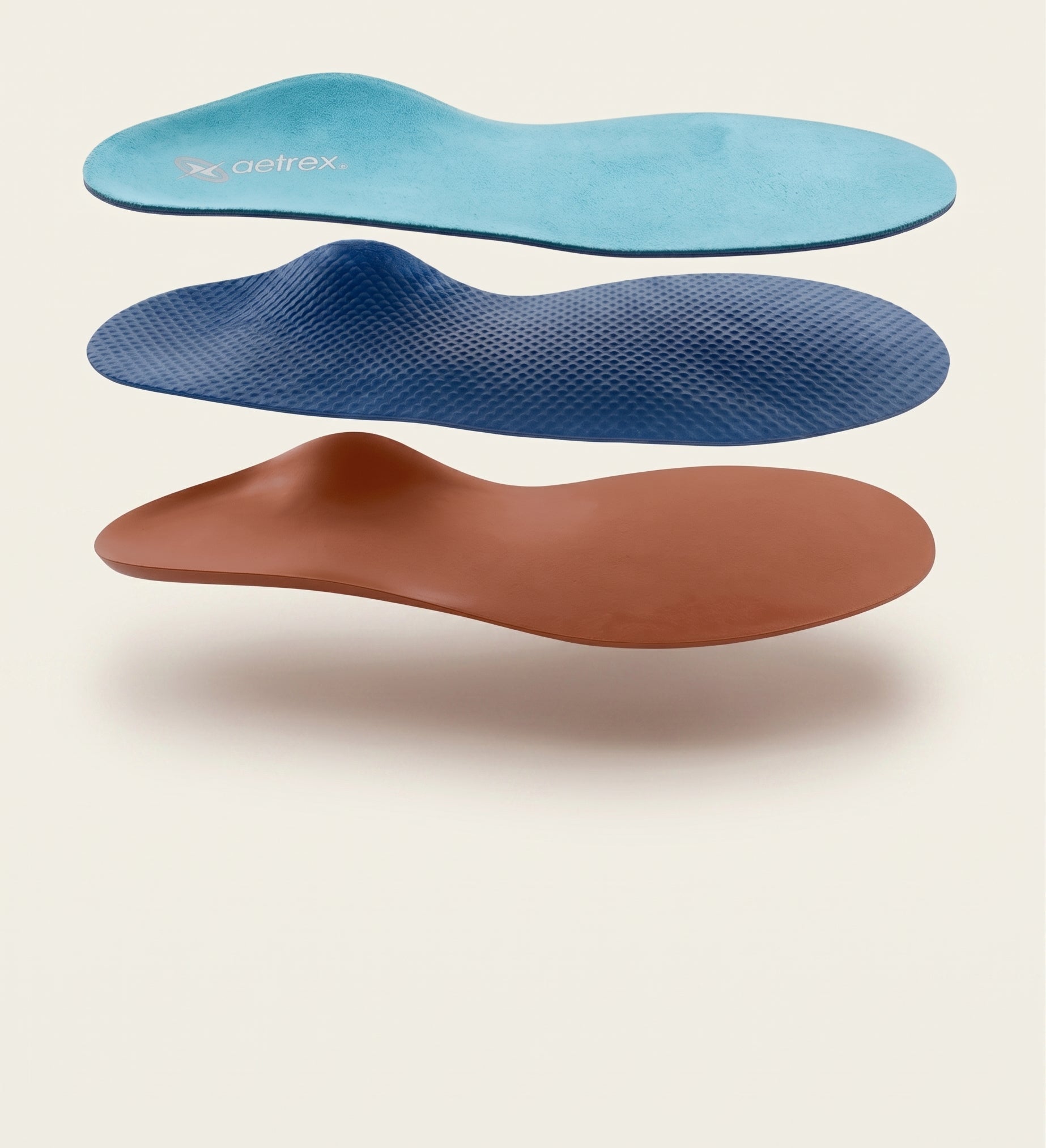 Three pairs of orthopedic insoles in blue, brown, and a lighter blue color on a beige background.