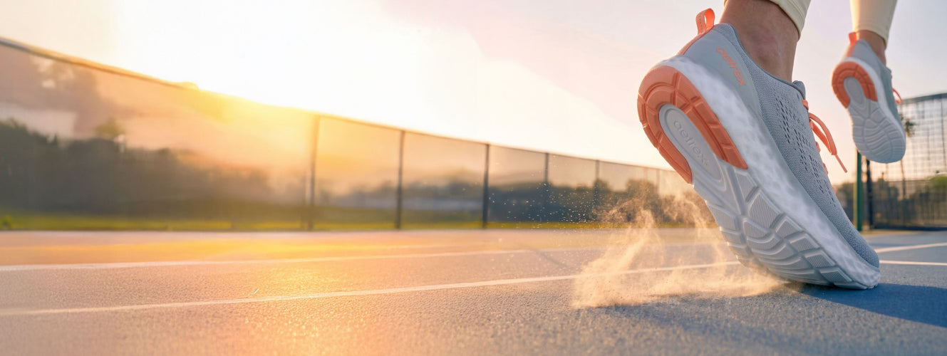 Person wearing blue running shoes on a track with a blurred background