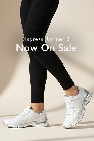 Person wearing black leggings and white sneakers with 'Xpress Runner 2 Now On Sale' text.