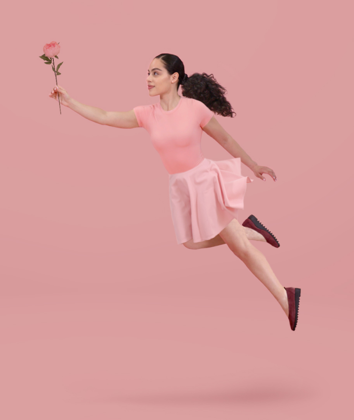 Girl floating in the air with a rose in her hand
