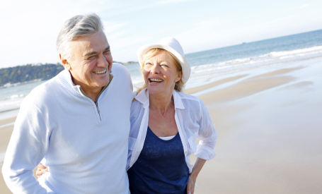 older couple walking on beach