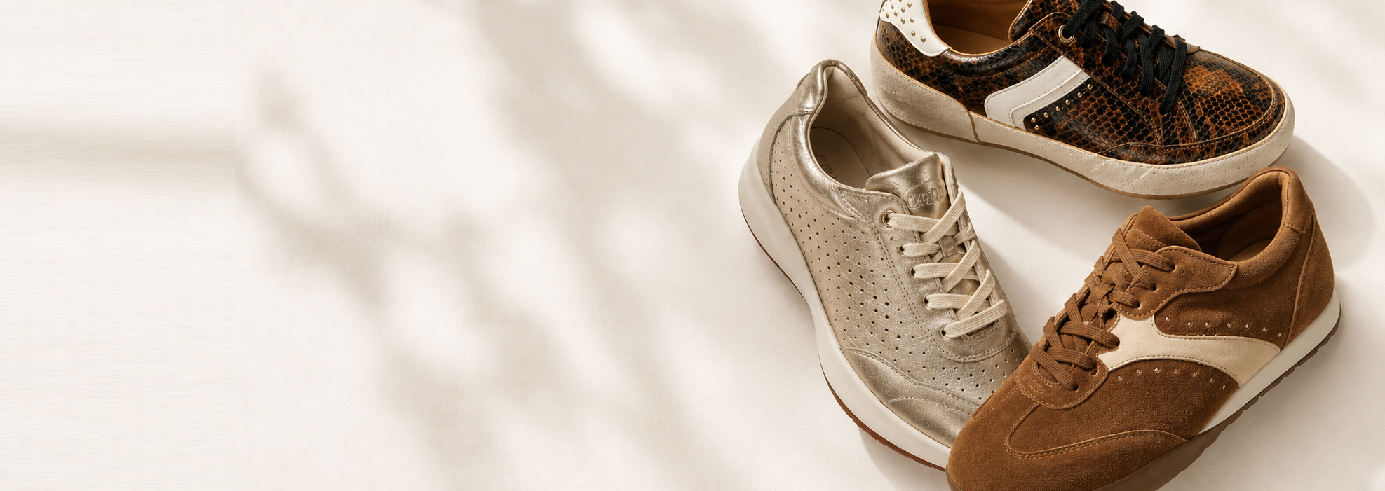 Pair of brown and beige sneakers on a light background