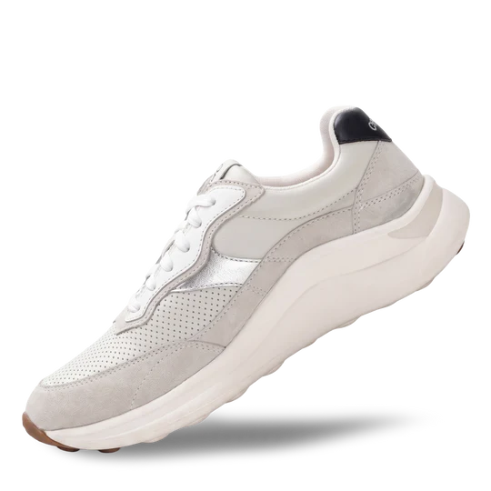 White sneaker with a black sole on a white background