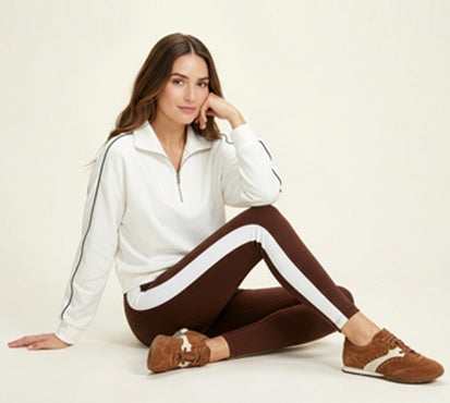 womens sitting in athletic outfit with brown sneakers